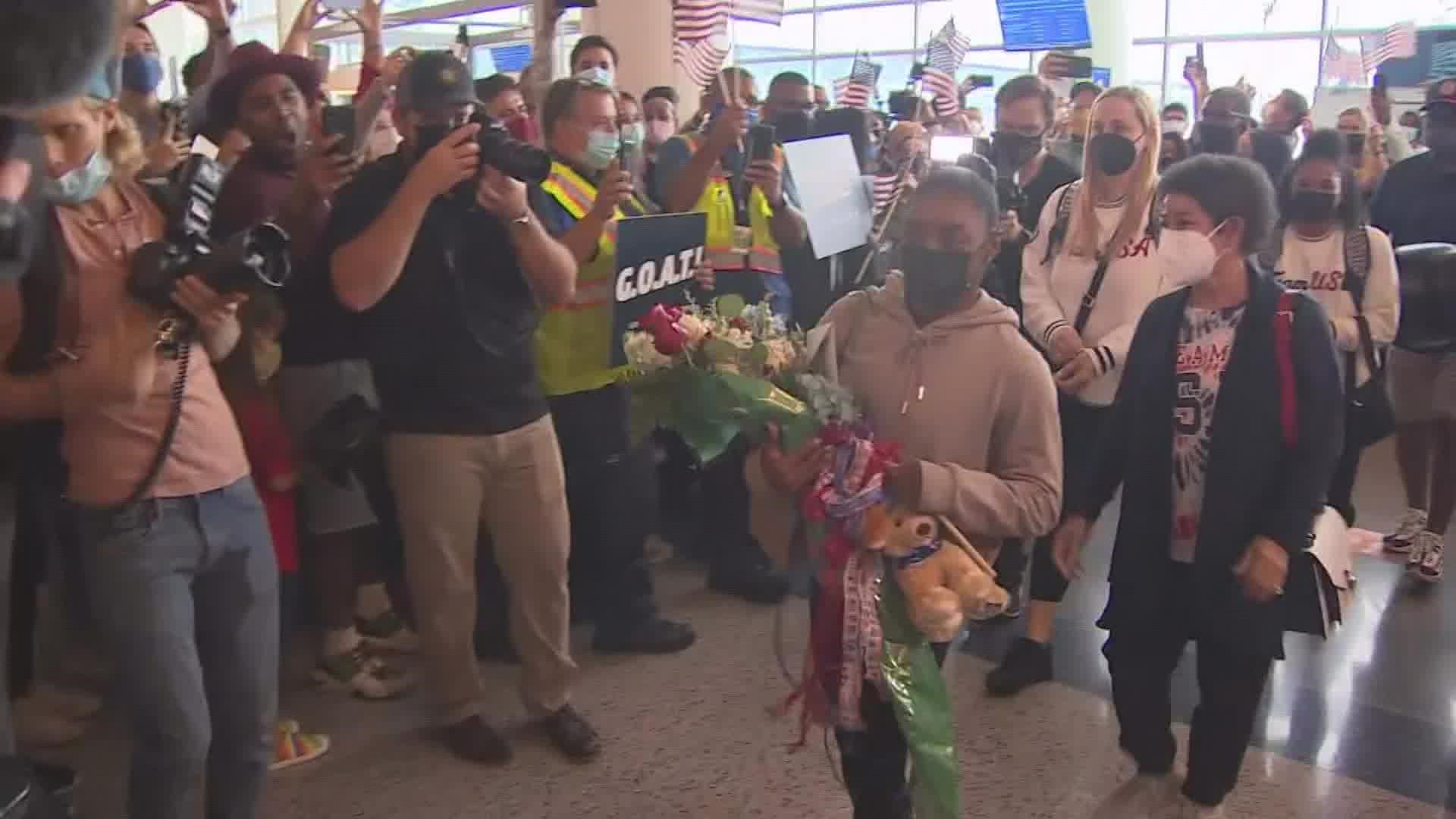 Crowds were at Bush Airport to greet the Olympians as they got off their flight and in Spring as they headed home.