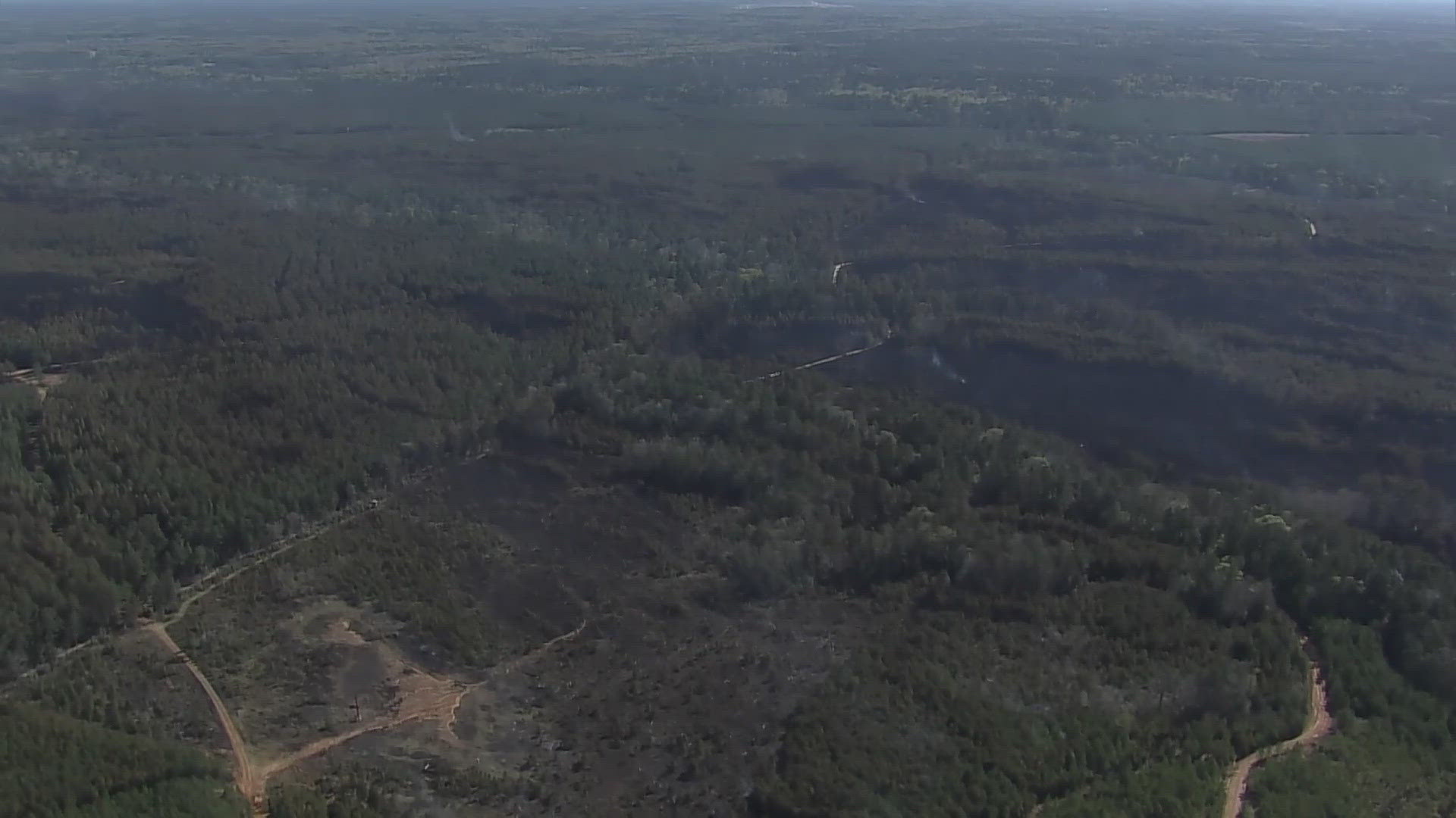 Air 11 helicopter shows the area burned in the Pauline Road Fire in Texas. Winds die down Thursday evening to help crews.