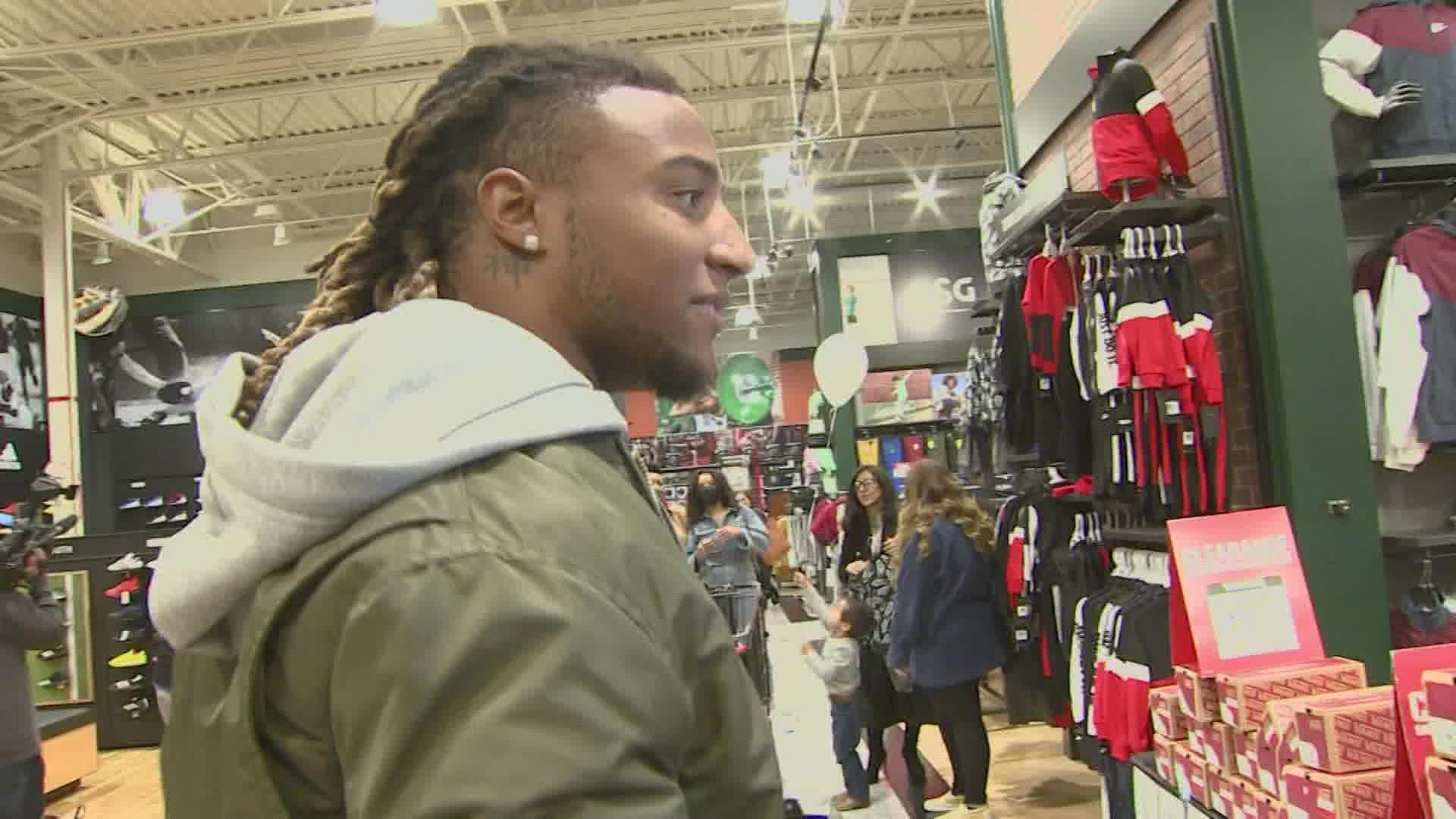 The Houston Texans safety took little boy Blaine on a shopping spree as his dad recovers in the hospital from the Christmas Eve shooting.