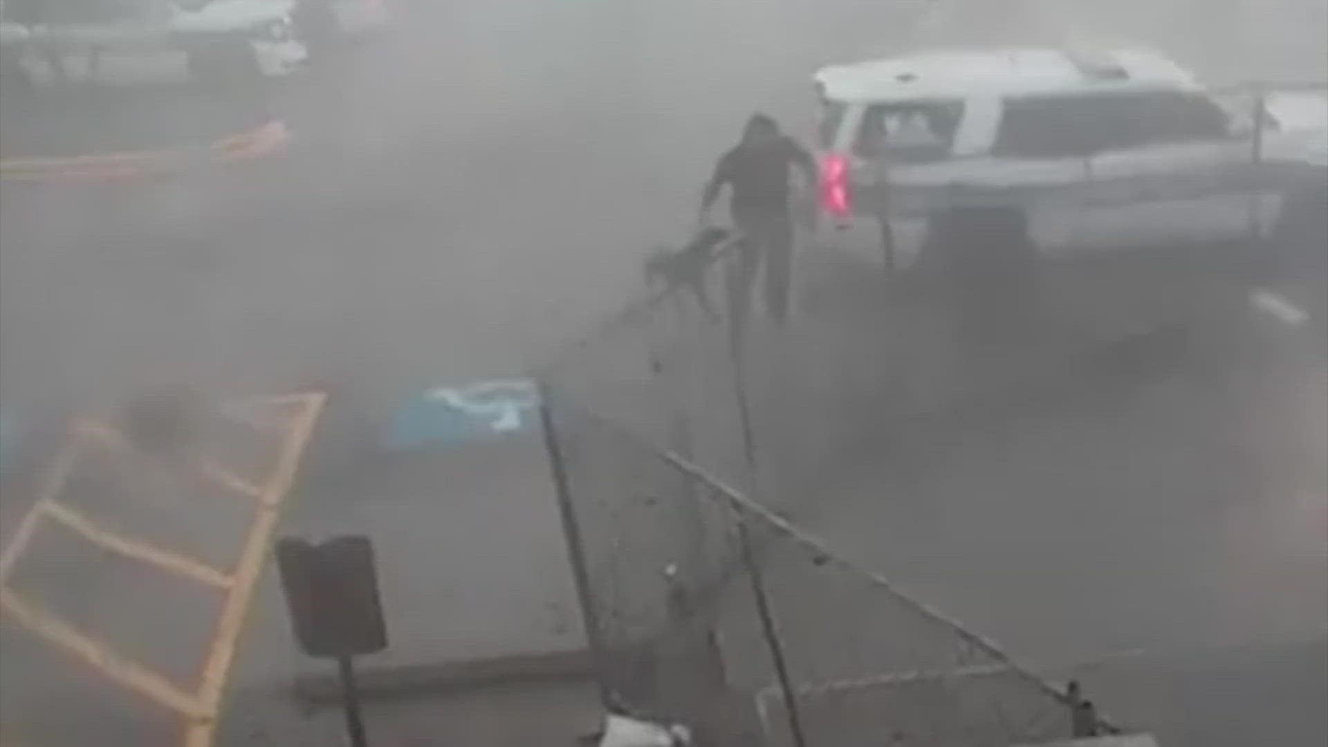 Viral video captures the moment officer Joel Nitchman rushed out into a dangerous storm to get his partner of 8 years to safety.