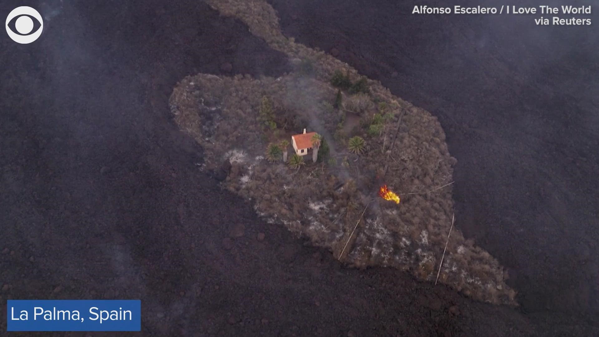Drone footage shot recently over the island of La Palma in Spain shows a single house spared from flowing lava