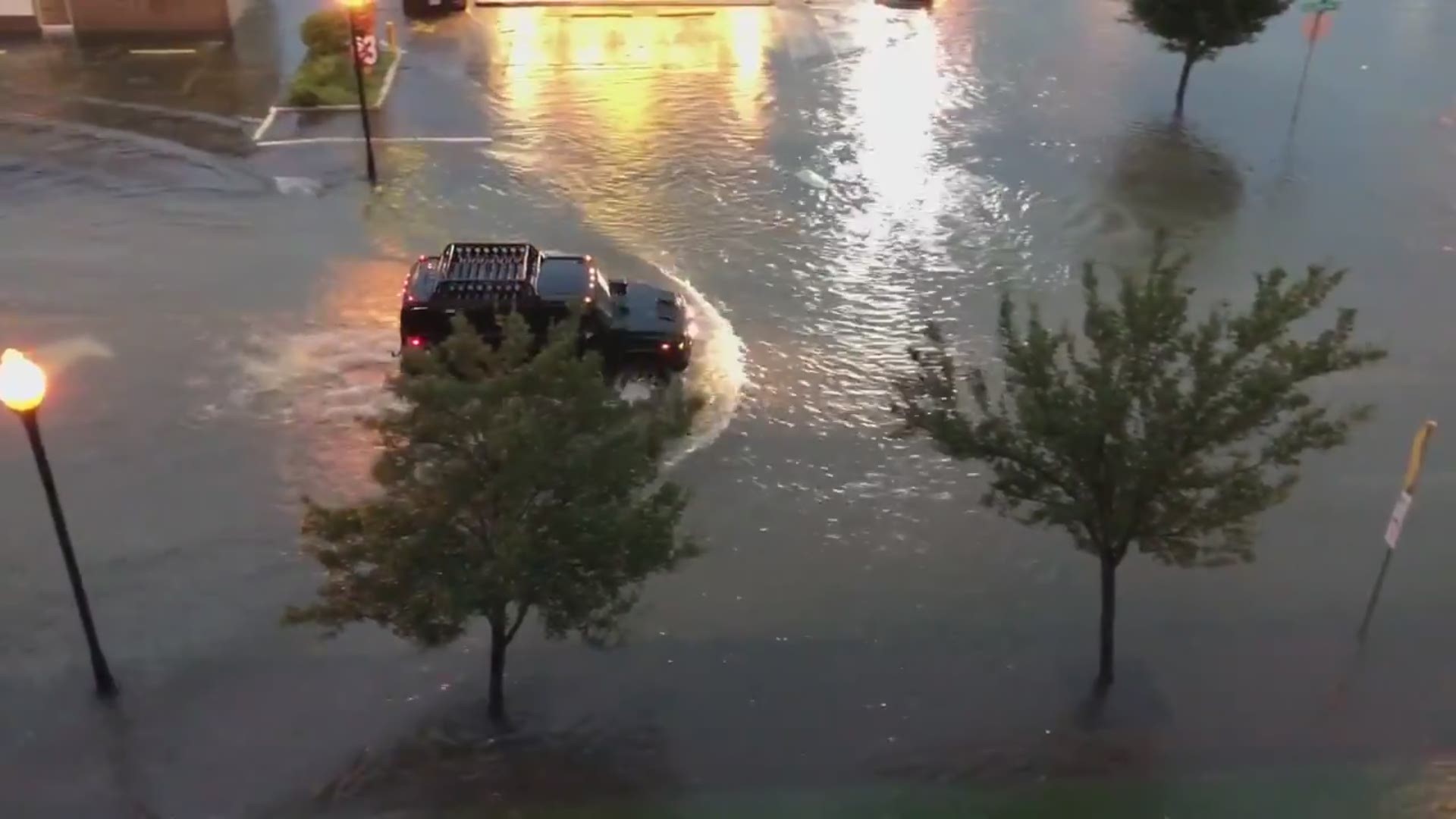 A car struggles to make it through flooded roads in Beaumont, Texas.