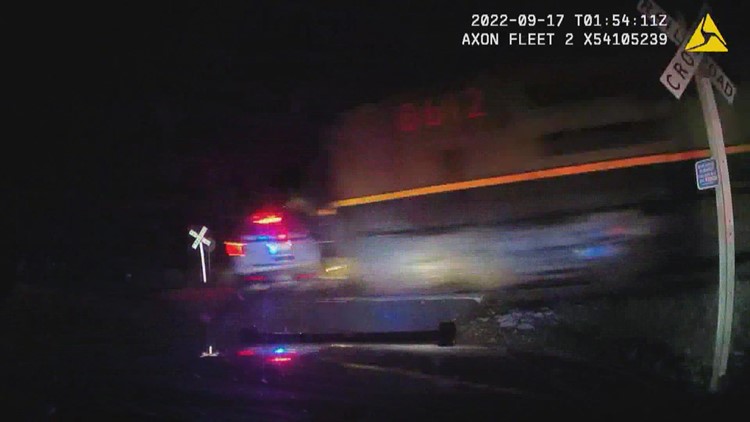 Video shows train crash into patrol car with suspect handcuffed in back seat