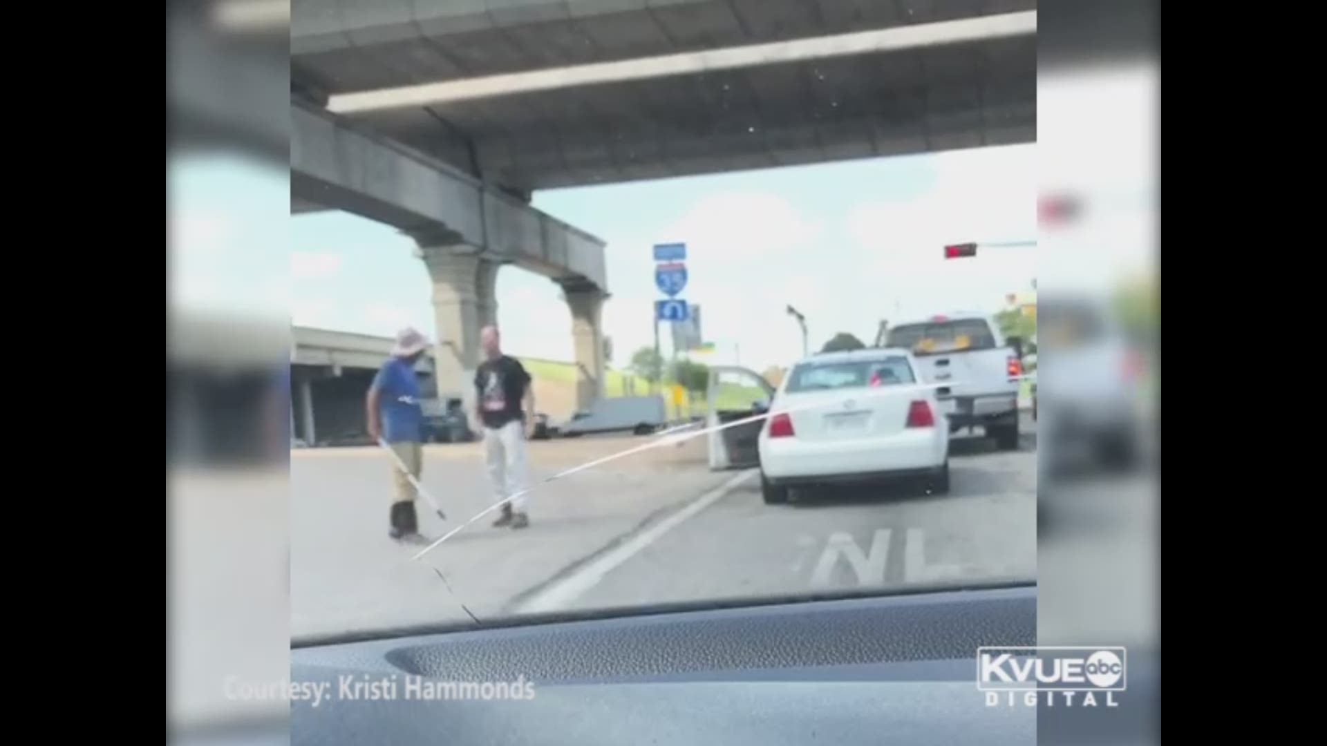 A shocking video appears to show a man getting out of his car and pushing another man in front of a vehicle at a North Austin intersection.