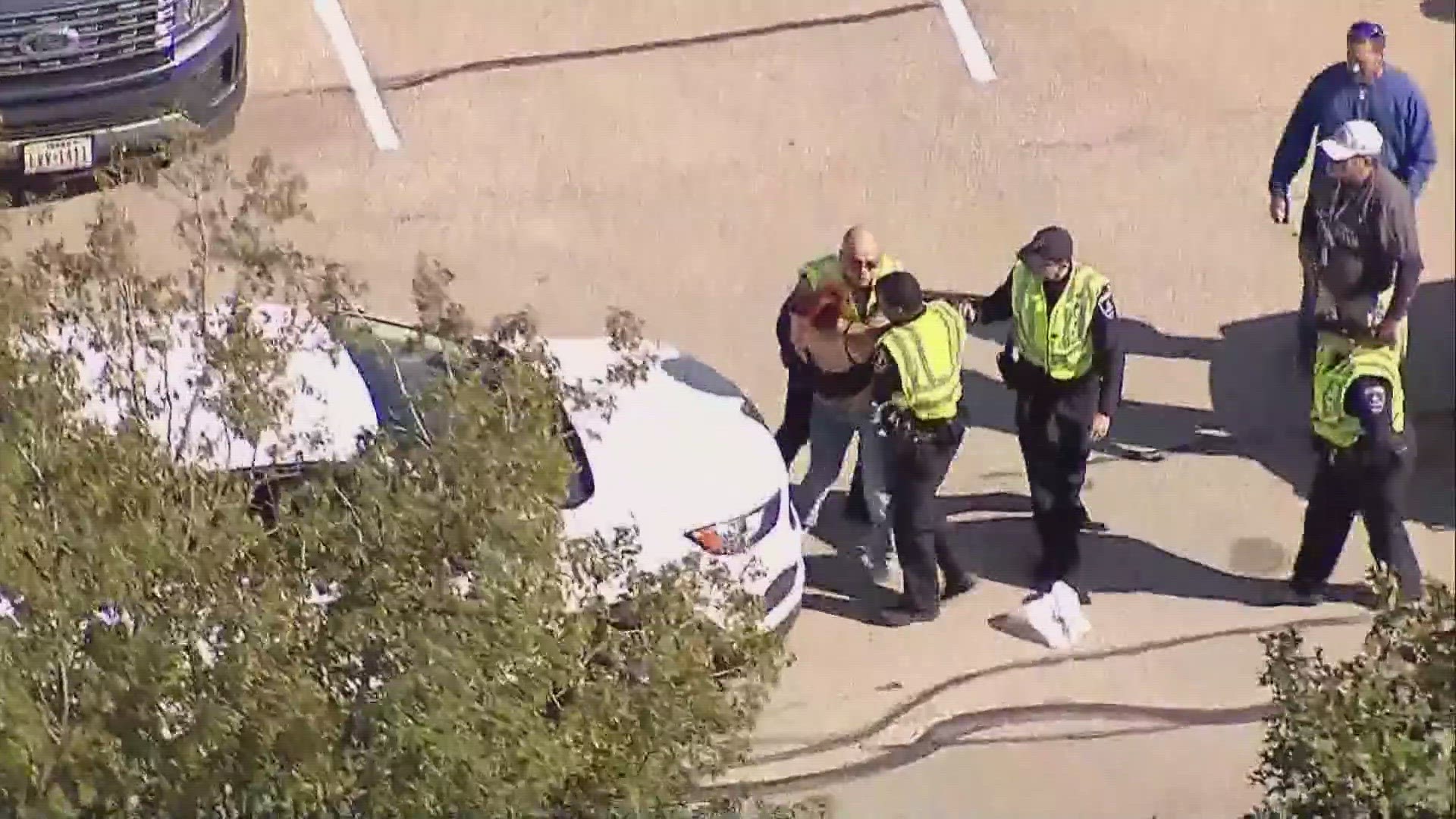 Police said the shooting occurred in Parking Lot 12 at AT&T Stadium near where the parade had just wrapped up. A suspect has been taken into custody, police said.