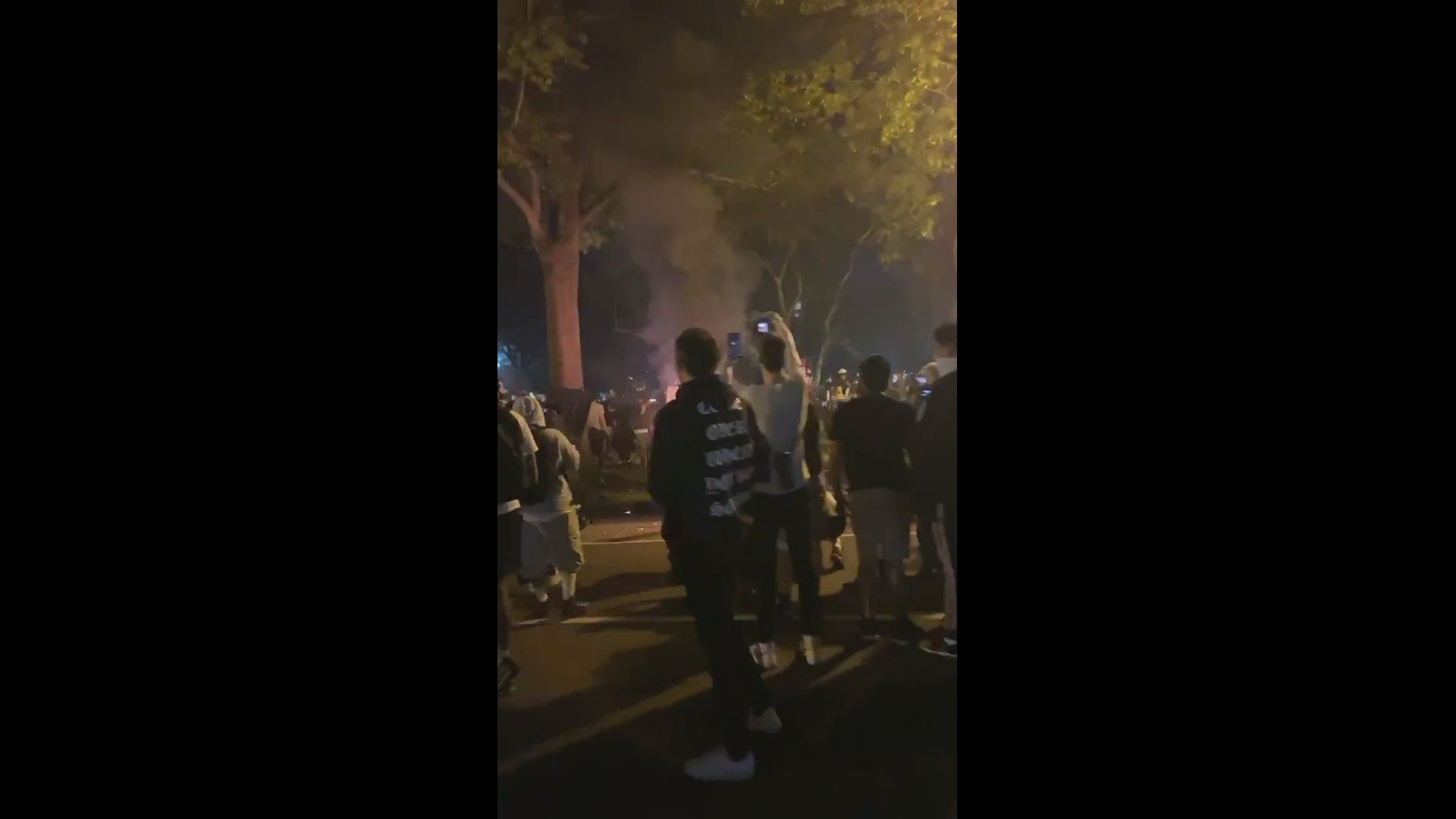 One local viewer captures protestors starting a trash can fire, claiming they threw in a scooter.