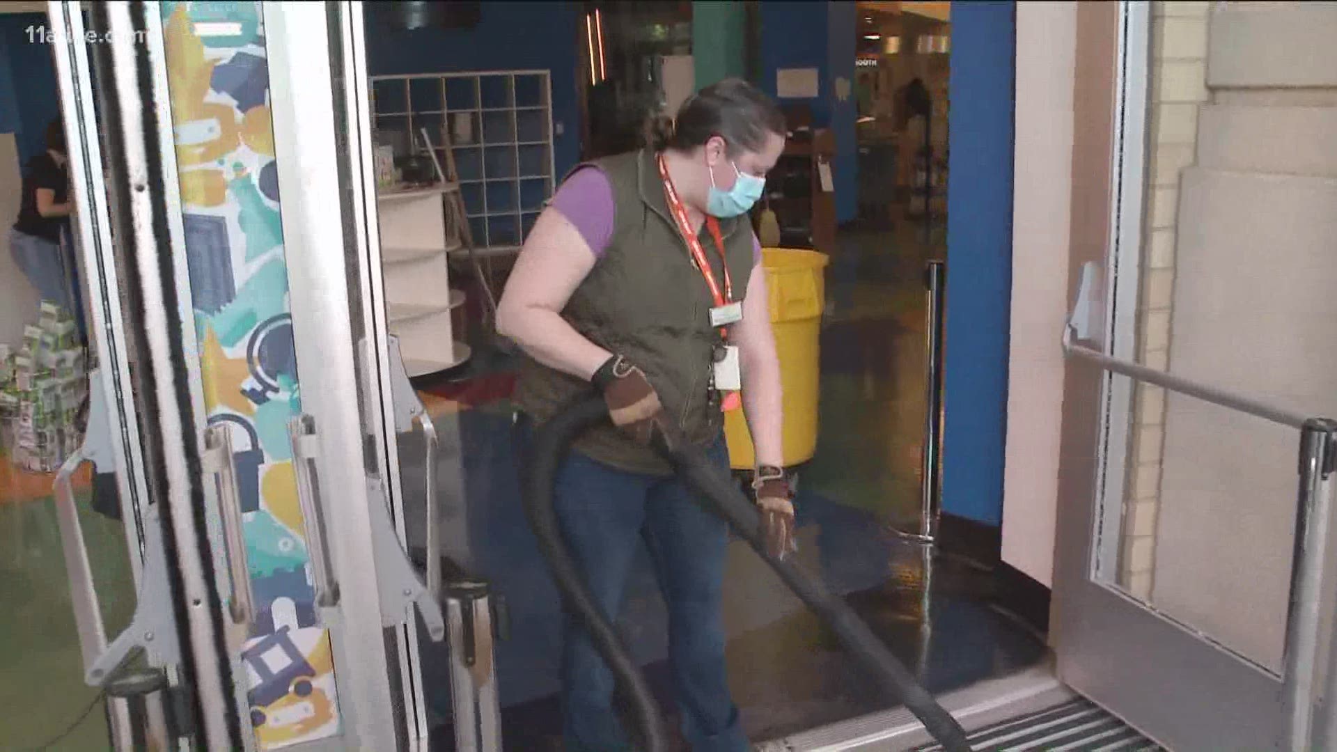 Volunteers showed up early Sunday morning to help clean up the shards of glass and other debris around the Atlanta Children's Museum following the damage there.