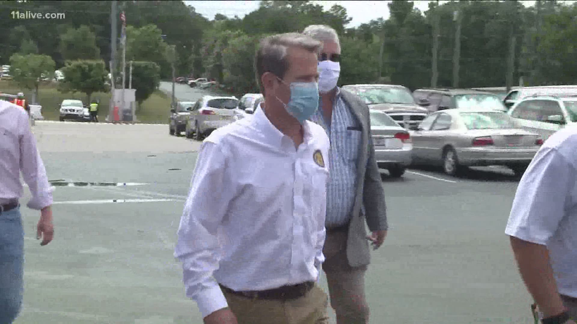The governor on Friday toured Hall County, once one of the state's worst hot spots.