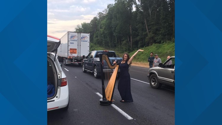 Interstate Angel | Woman plays harp in the middle of traffic jam on I-85
