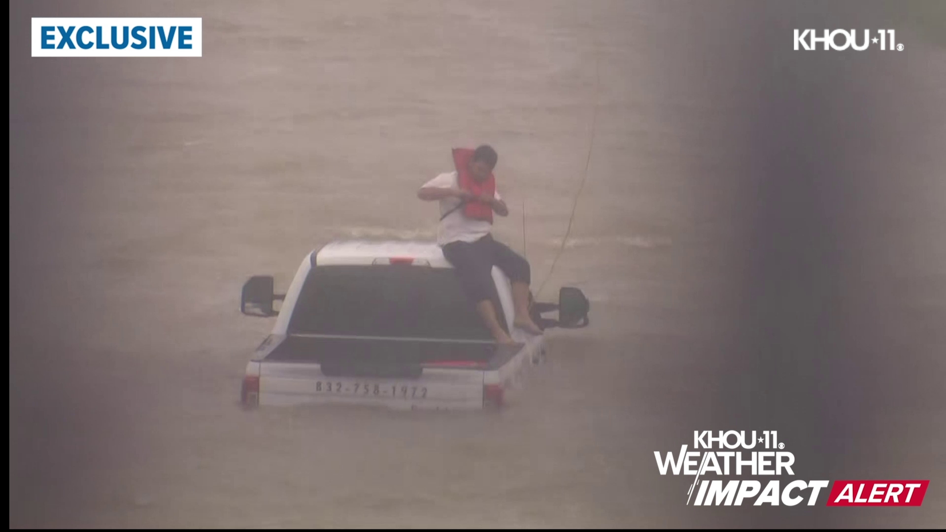 The man was forced to sit on top of the cab of the truck as he waited for first responders.